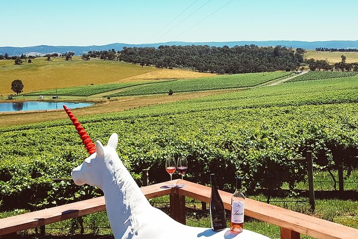 Vineyard rows and a cellar-door building in the Yarra Valley, Victoria